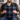 Man holding a Harris Tweed Denim MacLeod cushion in a living room setting