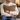 Man holding a Harris Tweed Dunmore Houndstooth cushion in a cozy living room setting