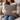 Woman holding a Harris Tweed Grey Herringbone cushion on a couch