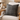 Harris Tweed Birch Tartan cushion on a cream chair with ornaments in the background