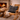 Harris Tweed Birch Tartan cushion on a rocking chair with an open fire in the background