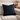 Harris Tweed Black Watch Tartan cushion on a cream sofa with a neutral background