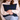 Person holding a blue Harris Tweed Black Watch Tartan cushion in a cozy indoor setting