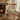 Wooden rocking chair with a Harris Tweed Duck Egg lumbar cushion in a cozy room with a fireplace and table.