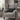 Grey armchair with Birch Tartan Harris Tweed lumbar cushion and blanket in a cozy living room setting.