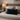 Bedroom with wooden headboard, Black Watch Harris Tweed lumbar cushion, and lamp on nightstand.