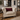 Beige armchair with a Harris Tweed Claret red lumbar cushion in a living room setting