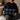 Woman holding a Harris Tweed Denim MacLeod cushion  on a couch with a neutral background