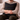Man holding a Harris Tweed Heather Glade cushion on a couch