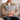 Man holding a tHarris Tweed Light Grey Marl cushion on a couch