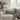 Harris Tweed Light Grey Marl lumbar cushion on a sofa in a room with large windows