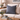 Harris Tweed Lomond Barleycorn cushion on a beige sofa with decorative items on a wooden coffee table.