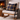 Rocking chair with Harris Tweed MacKenzie Tartan cushion in front of a fireplace