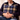 Man holding a Harris Tweed MacKenzie Tartan cushion with a neutral background