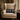 Harris Tweed MacKenzie Tartan lumbar cushion on an armchair beside a window