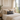Harris Tweed MacKenzie Tartan lumbar cushion on a bed, in a room with large windows