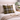 Harris Tweed MacLeod Tartan cushion on a bed with an open book and a lamp in the background