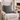 Gray armchair with a Harris Tweed Grey Marl cushion in a cozy living room setting.