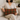 Woman holding a Harris Tweed Moss, Gingerbread & Wine lumbar cushion on a couch