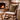 Wooden rocking chair with Harris Tweed Moss cushion in front of a stone fireplace.