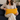 Woman holding a Harris Tweed Mustard yellow lumbar cushion on a dark blue couch