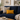 Navy blue sofa with a Harris Tweed Mustard yellow lumbar cushion in a living room setting.