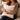 Woman holding a Harris Tweed Oatmeal cushion on a couch