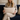 Woman holding a Harris Tweed Oatmeal lumbar cushion on a navy blue couch