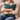 Man holding a Peacock Harris Tweed cushion on a beige sofa.