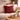 Cream sofa in a neutral room, with a wooden table, plants and a Harris Tweed Royal Stewart Tartan cushion