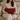 Woman seated on a sofa holding a Harris Tweed Royal Stewart Tartan lumbar cushion
