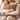 Woman holding a Harris Tweed Sollas Tartan cushion on a sofa