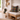Nestled entryway with wooden bench, Harris Tweed Stornoway Tarton cushion, and green wellington boots.