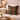 Harris Tweed Stornoway Tarton cushion on a white sofa with a candle and books on a wooden table in a cozy living room.