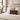 Bedroom with a Harris Tweed Stornoway Tartan lumbar cushion on a bed, lamp, and window.