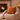 Cozy living room with a fireplace, bean bag chair, and Harris Tweed Terracotta cushion