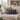Harris Tweed Thistle & Flint Wave lumbar cushion on a beige sofa in a living room with decor elements.
