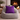 Gray bean bag chair with a Harris Tweed Thistle purple cushion in front of a fireplace.