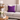 Gray sofa with a Harris Tweed Thistle purple cushion in a living room setting