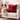 Beige armchair with a red Harris Tweed Winterberry Tartan cushion and beige blanket in a cozy living room setting.