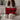 Woman seated on a sofa holding a Harris Tweed Winterberry Tartan lumbar cushion