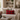 Cozy living room with a beige sofa, Harris Tweed Winterberry Tartan lumbar cushion, and decorative items.